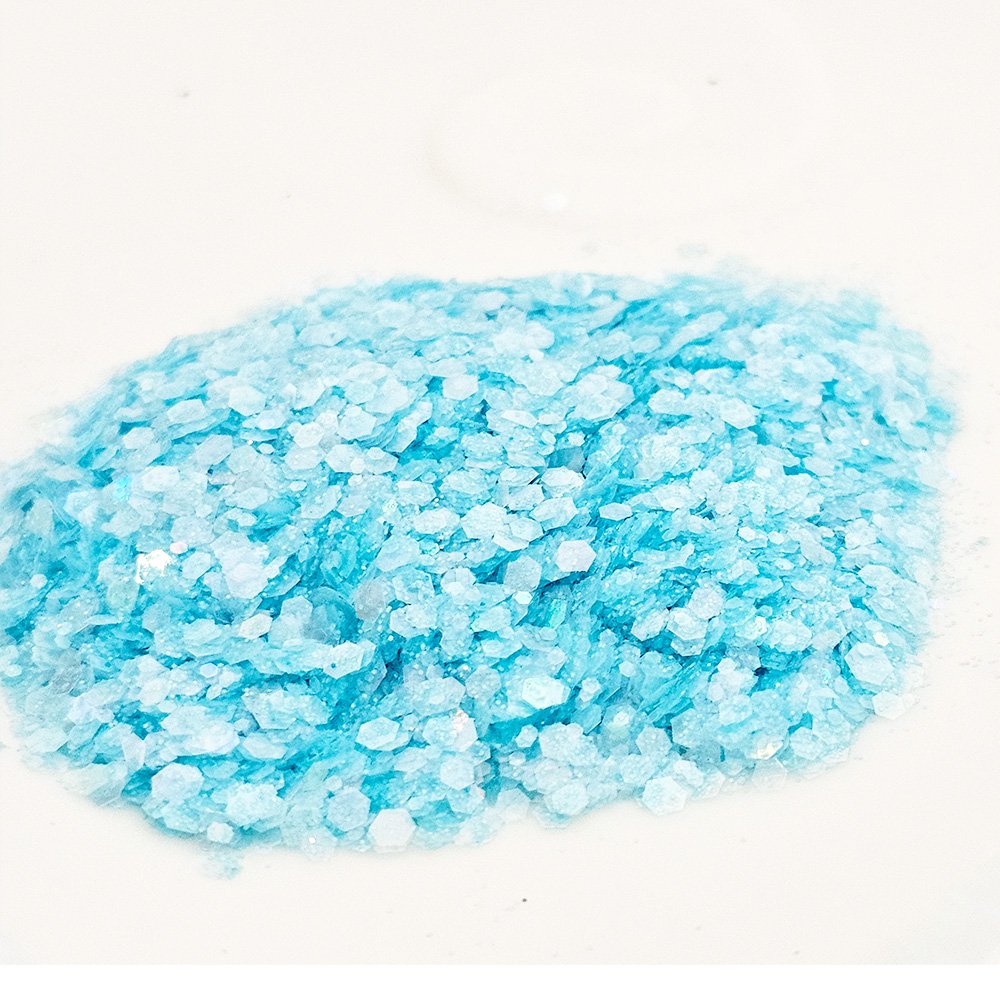 Pastel icy blue chunky glitter with soft shimmer on a white background