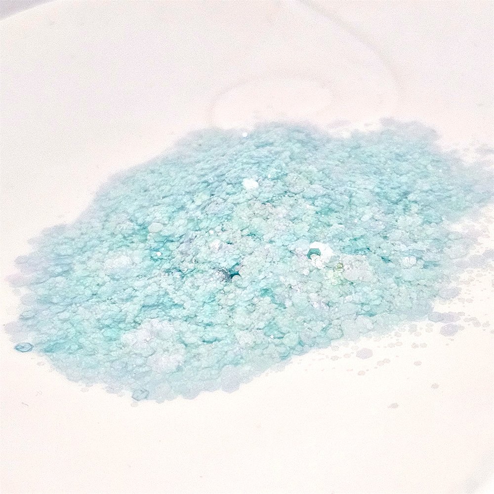 Fine pastel mint blue glitter with soft shimmer on a white background