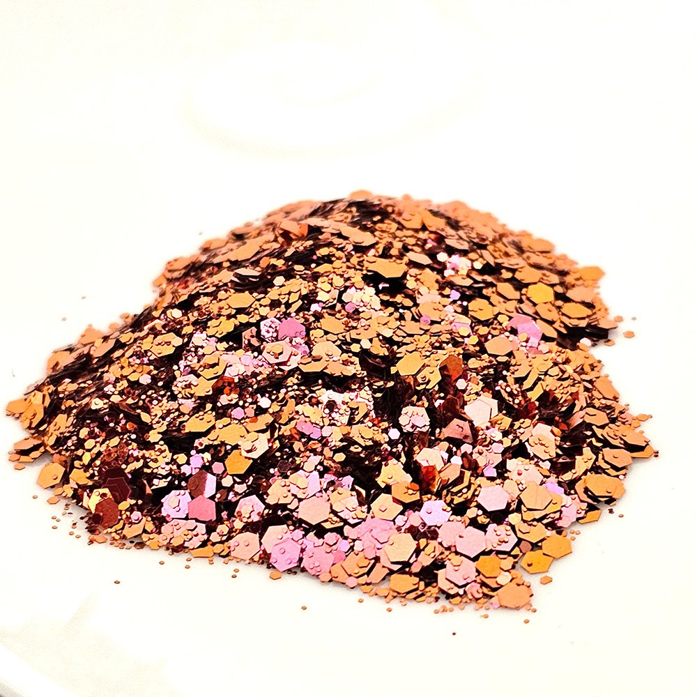 Rose gold and pink chunky glitter mix with metallic shimmer on a white background