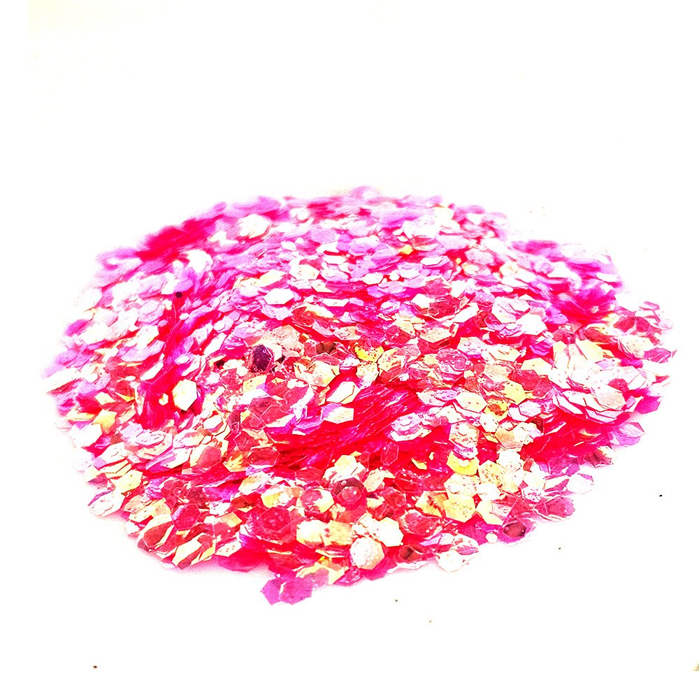 Hot pink chunky glitter with gold iridescent shimmer on a white background