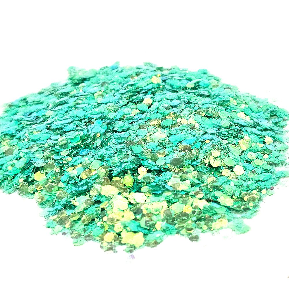 Chunky green glitter with golden shimmer flakes on a white background