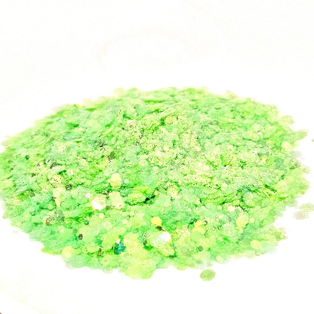Bright pastel neon green glitter mix with fine and chunky flakes on a white background