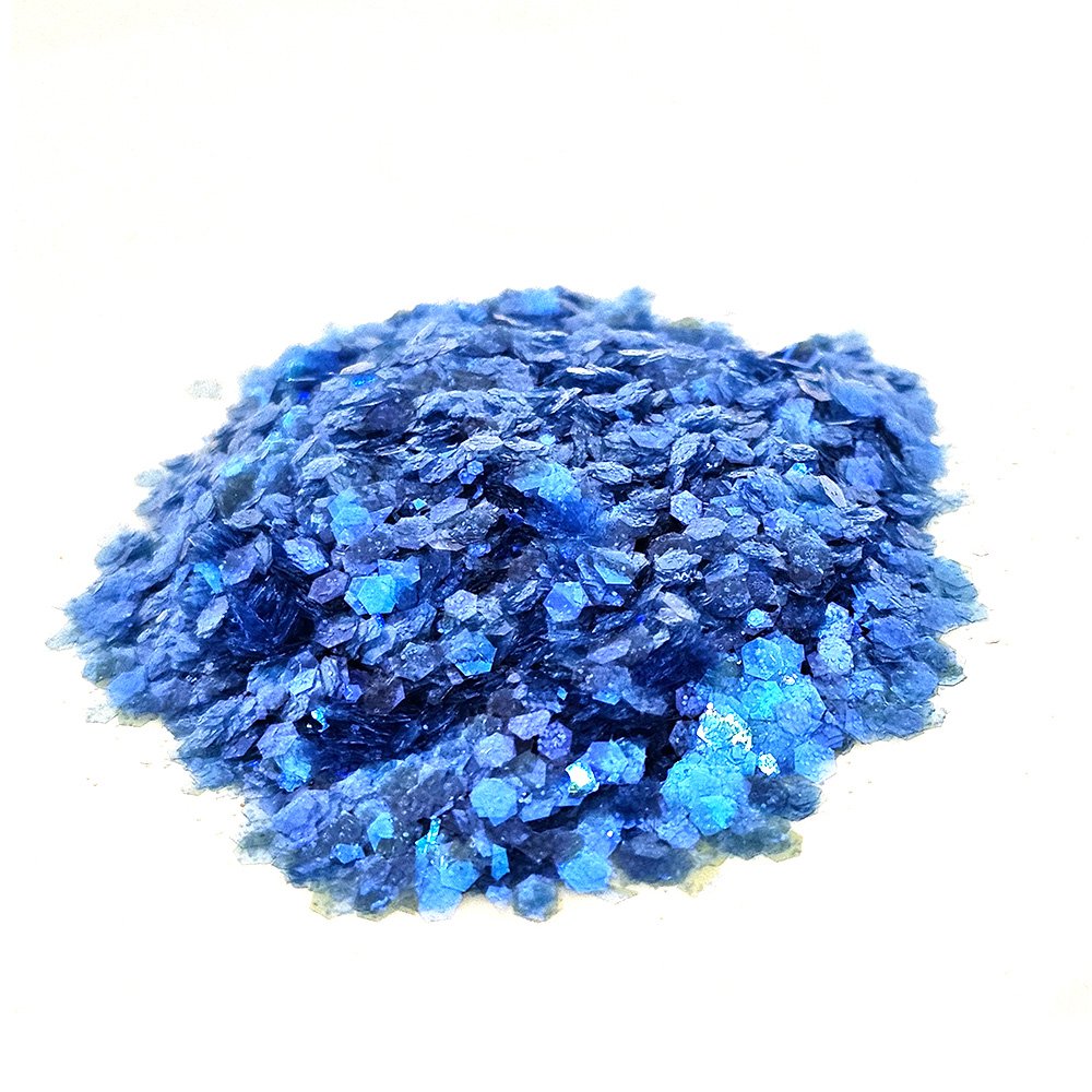 Deep sapphire blue glitter mix with fine and chunky flakes on a white background