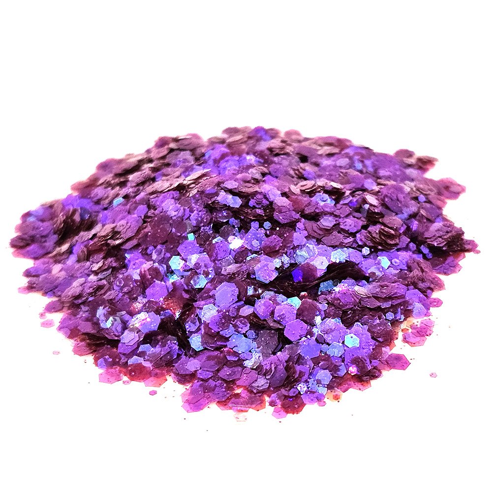 Chunky purple glitter mix with iridescent shimmer on a white background