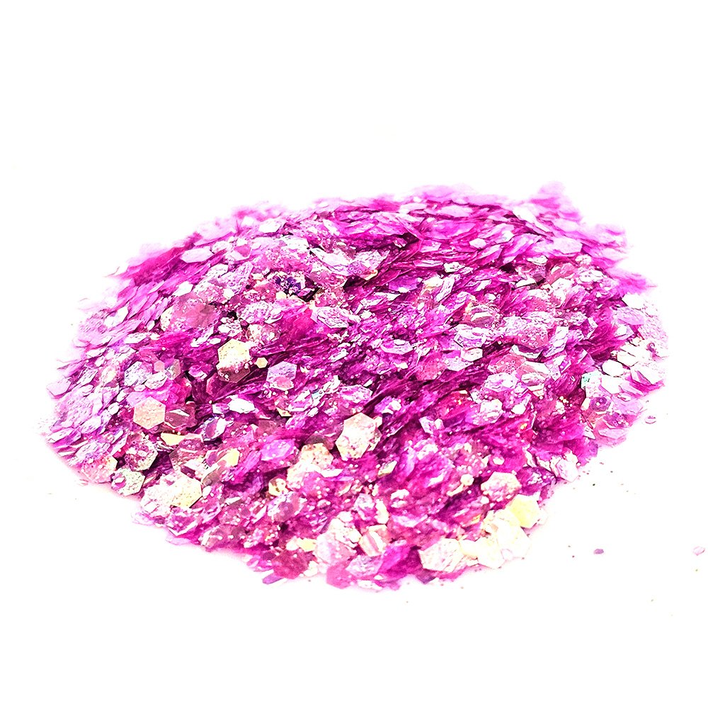 Chunky fuchsia pink glitter mix with iridescent and gold flakes on a white background